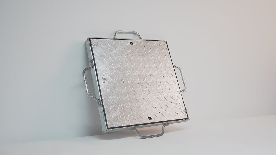 Galvanised steel checker plate pit cover with reinforced frame, designed for heavy-duty applications like driveways, loading docks, and industrial sites. Offers a solid, non-slip surface with concealed drainage access.