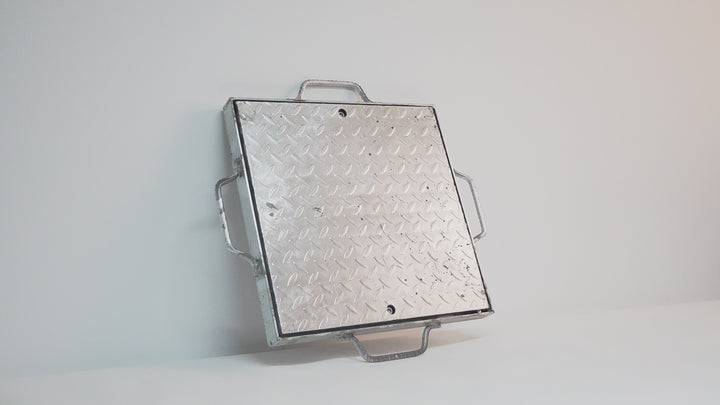 Galvanised steel checker plate pit cover with reinforced frame, designed for heavy-duty applications like driveways, loading docks, and industrial sites. Offers a solid, non-slip surface with concealed drainage access.